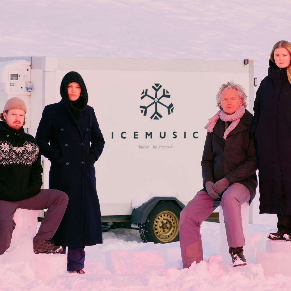 Ice Music Trailer - the quartet stand and sit in front of the trailer surrounded by snow.